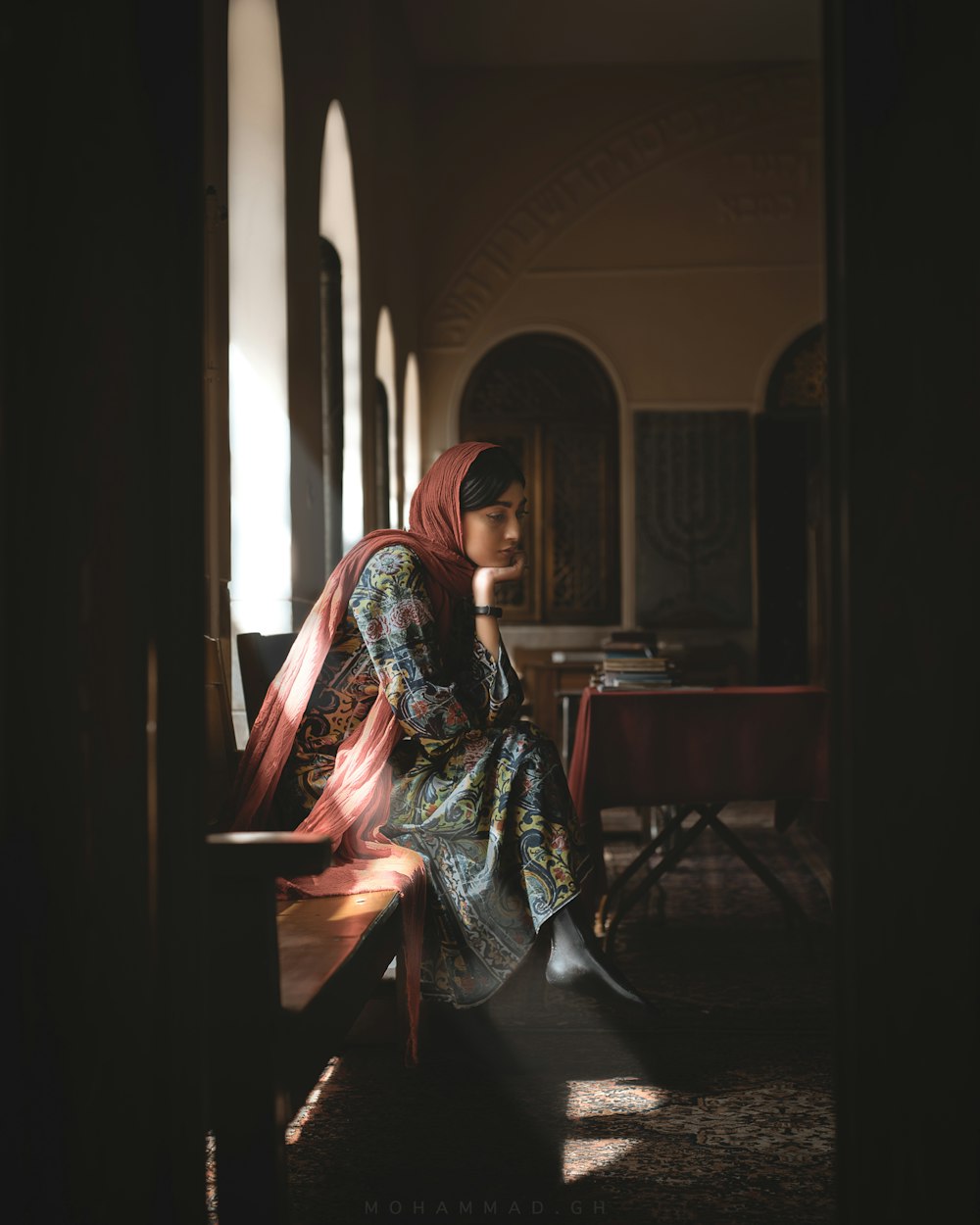 woman sitting on chair while looking down