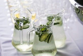 clear glass pitcher filled with cucumber detox water