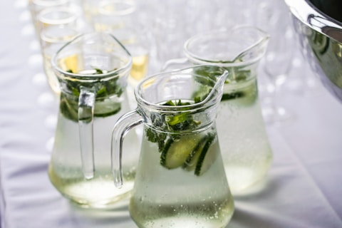 clear glass pitcher filled with cucumber detox water