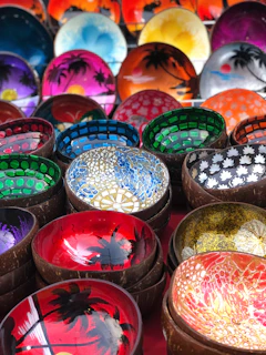 Handcrafted ceramic bowls with playful patterns in bright blues and oranges.
