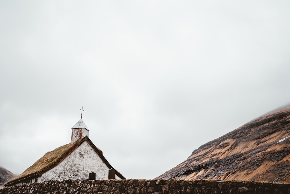 white concrete church under cloudy sky