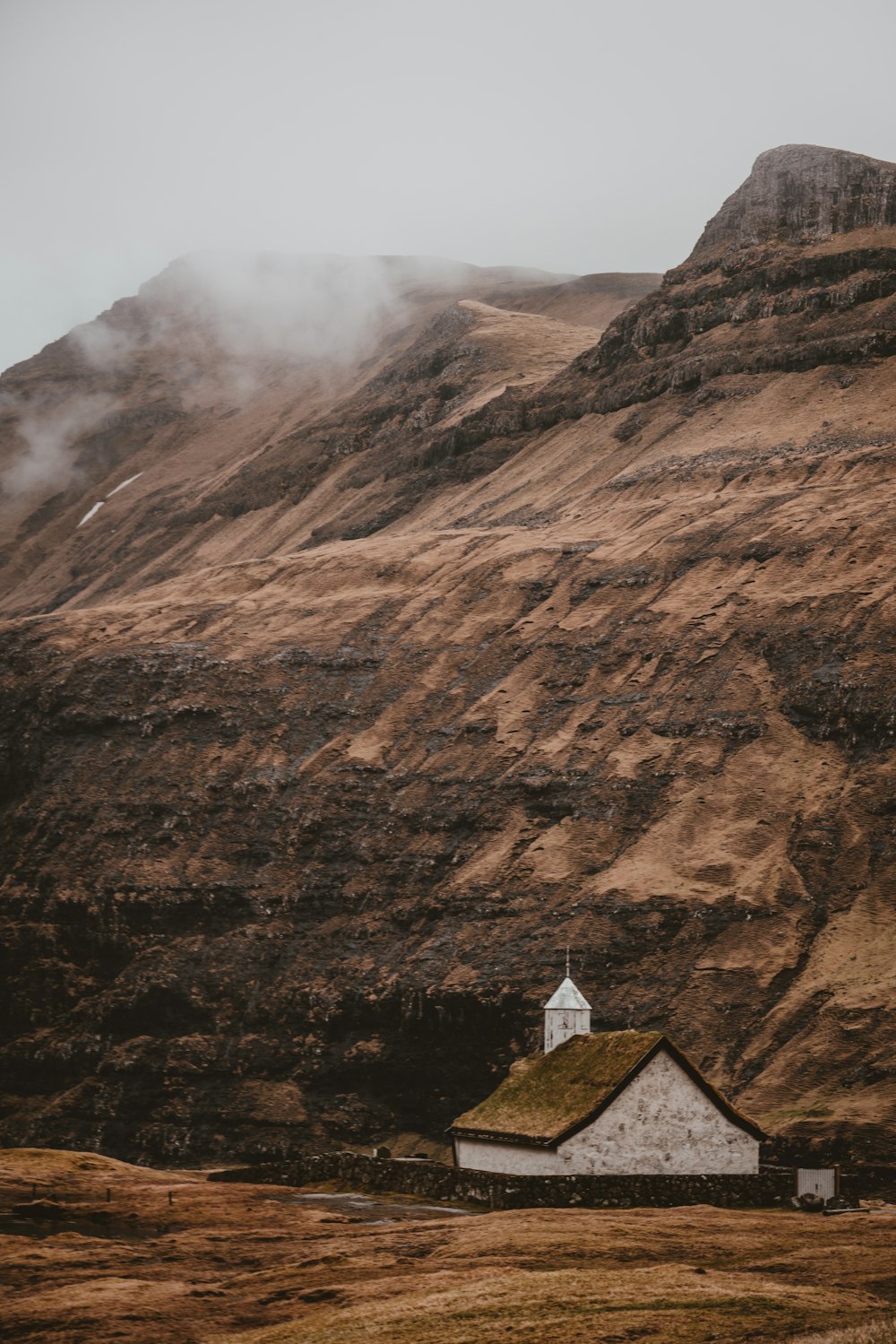 white shed beside mountian