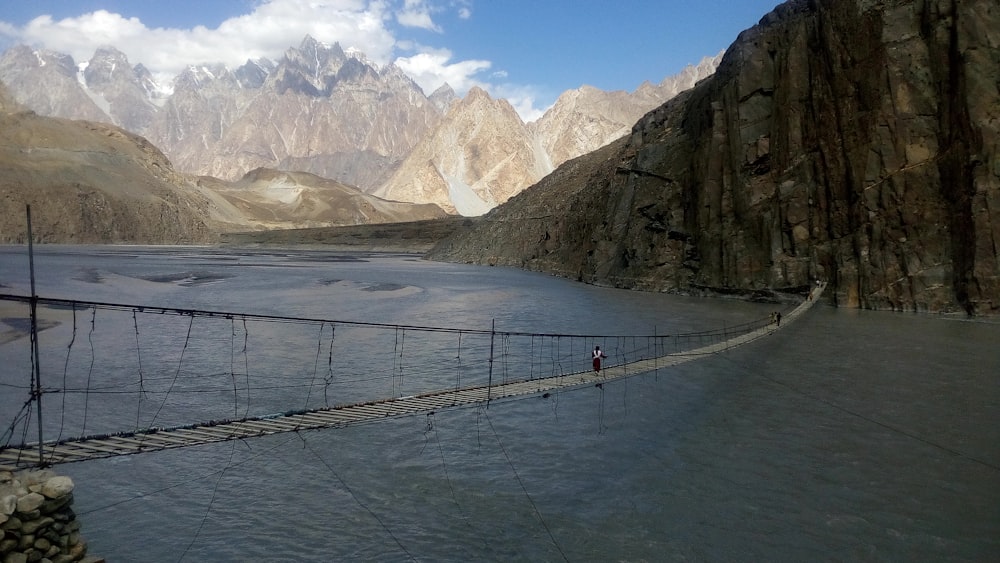 people walking on hanging bridge during daytime