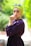 woman wearing purple long-sleeved top holding her lips during daytime