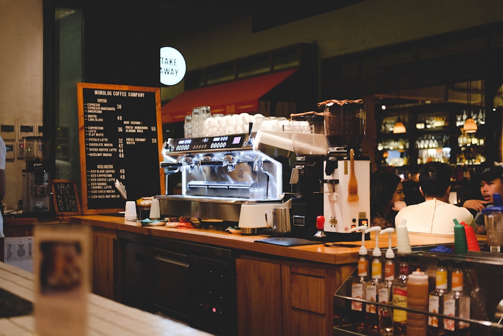 woman sitting beside front desk of cafe