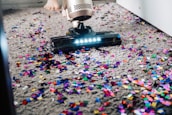 a person using a vacuum to clean a carpet