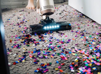Close-up of a professional vacuuming dust from air ducts.
