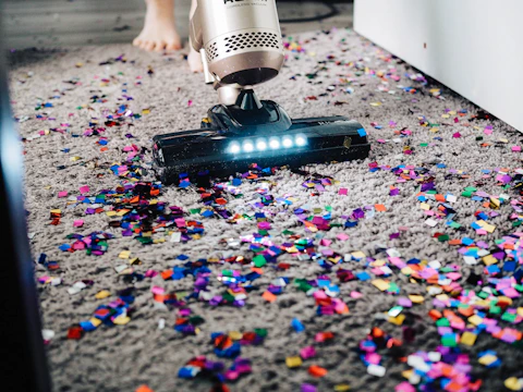 A team member vacuuming a commercial hallway with professional equipment.