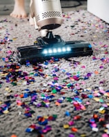 a person using a vacuum to clean a carpet