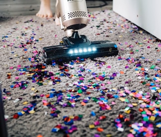 a person using a vacuum to clean a carpet