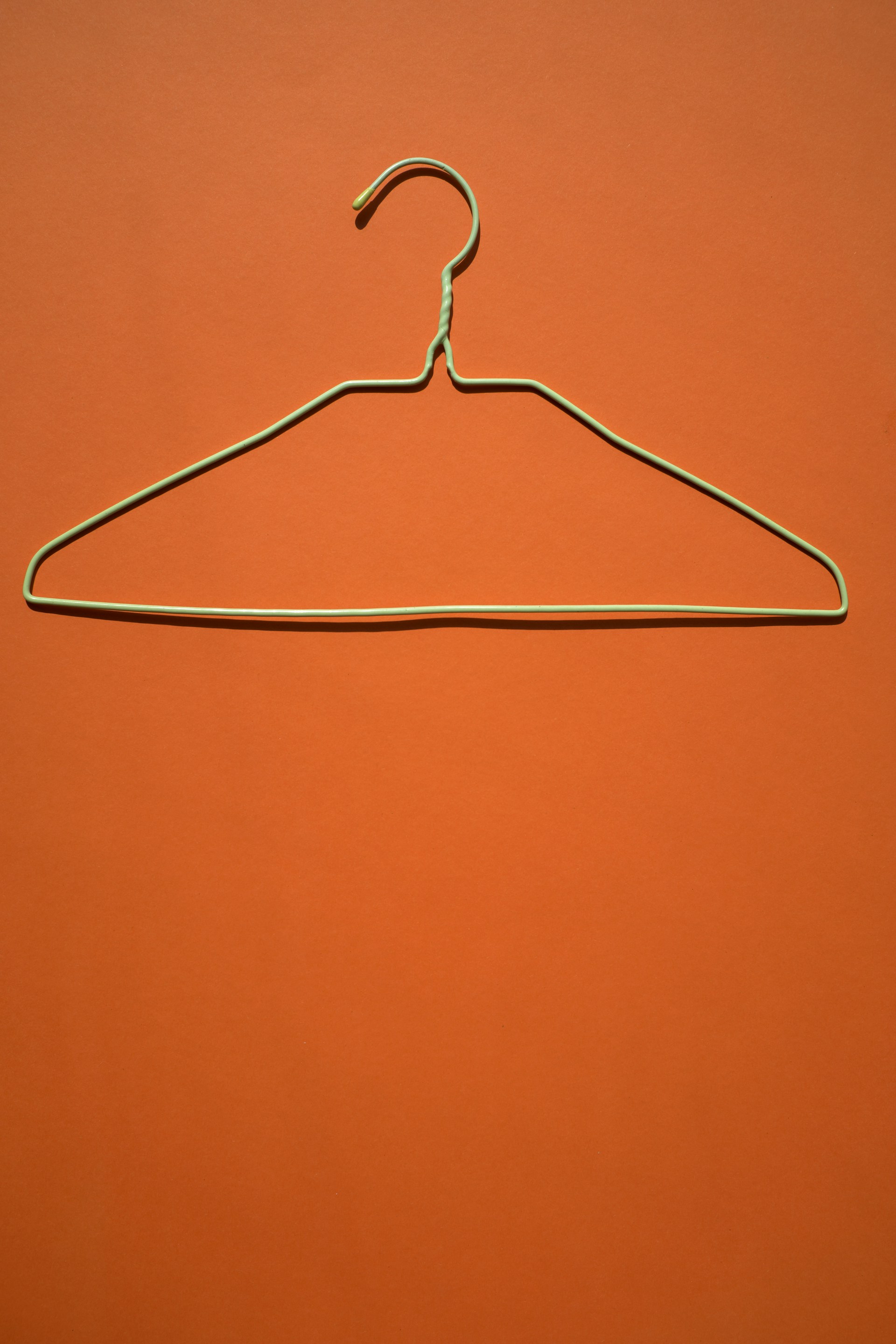 white clothes hanger on orange flooring