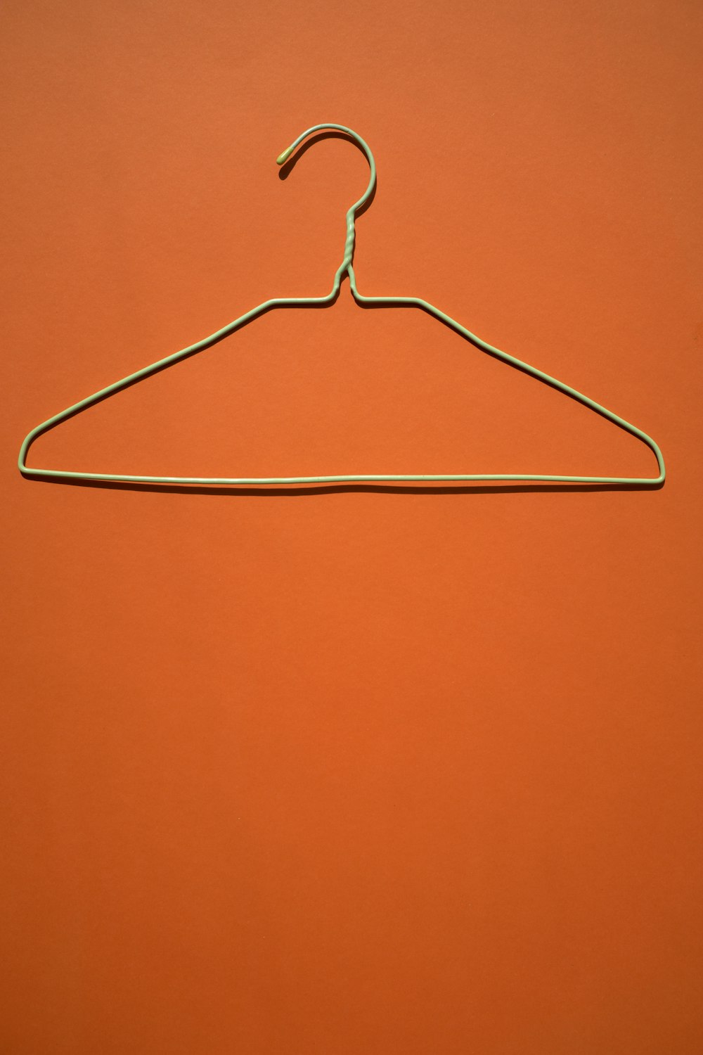 white clothes hanger on orange flooring
