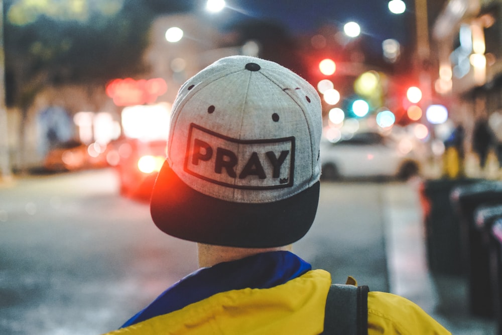 selective focus photo of person wearing black and gray cap