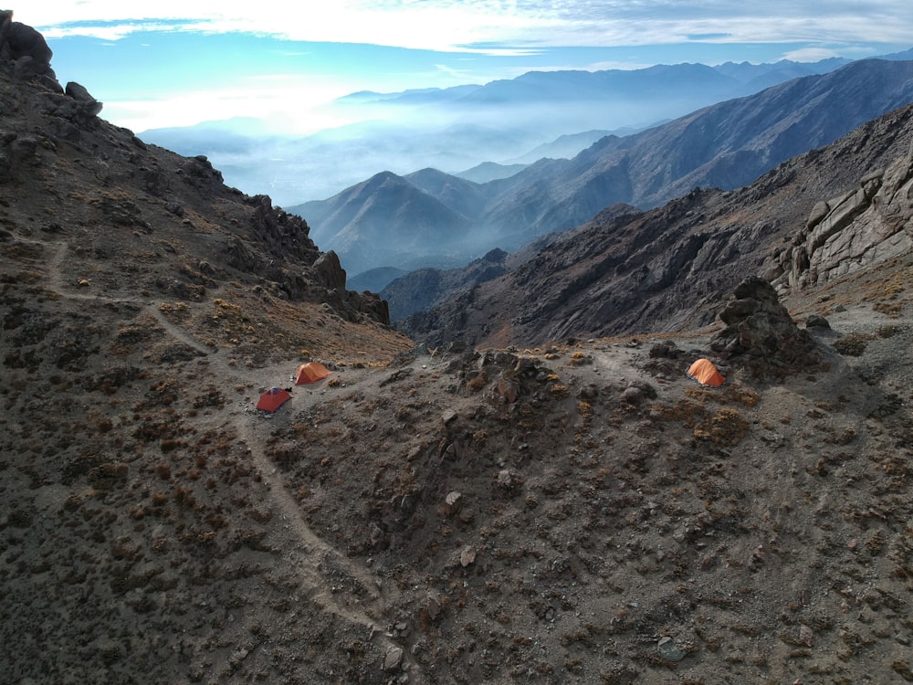 orange tent on top of mountain