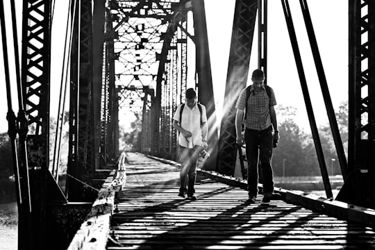 grayscale photography of two men on bridge in Waco United States