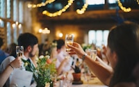 people raising wine glass in selective focus photography