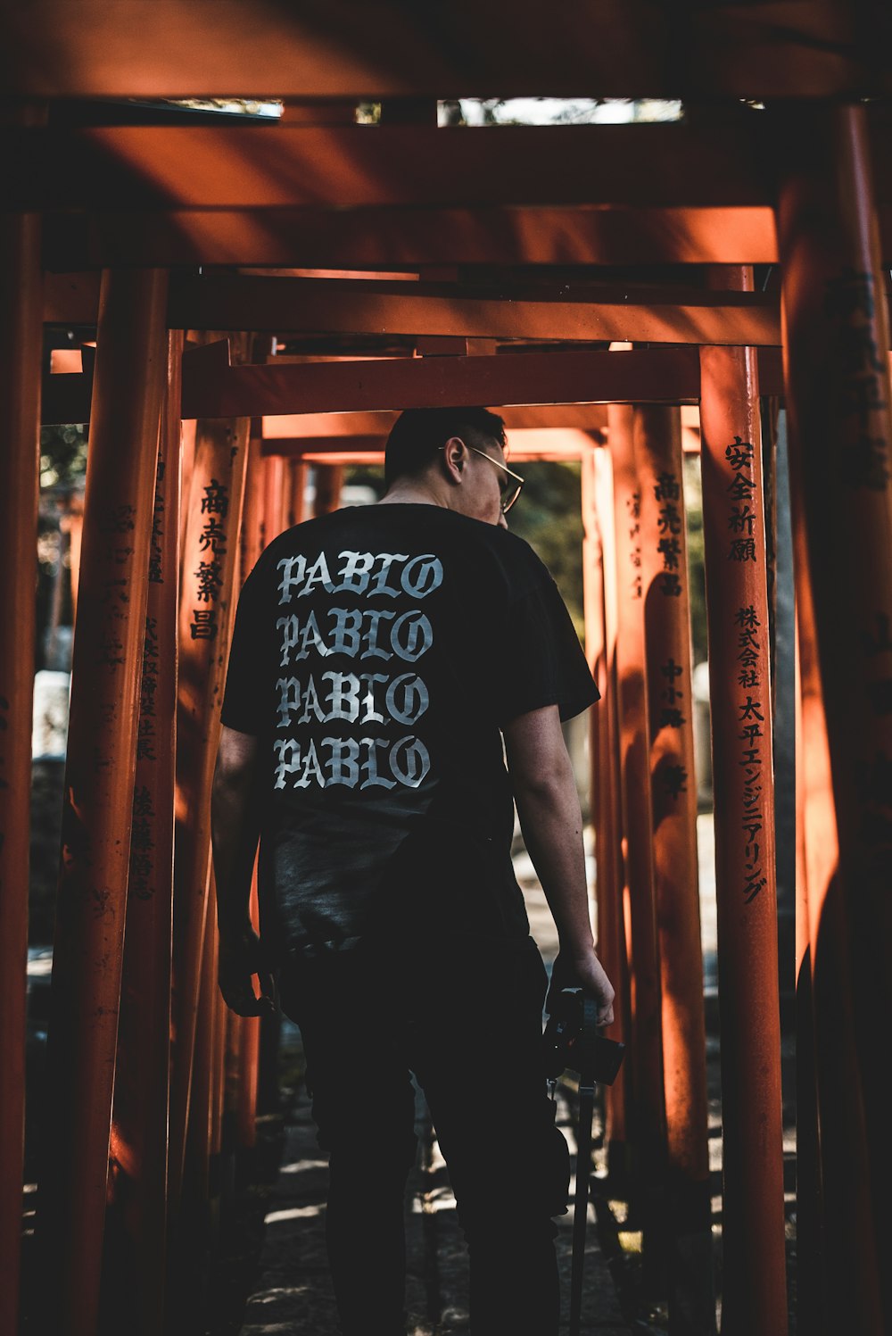 man standing in between orange metal frames