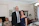 A smiling homeowner standing proudly in front of their newly renovated living room.