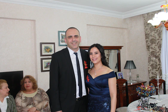 A friendly real estate agent showing a happy couple their new home.