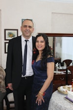 A well-dressed man and woman in formal attire, exuding confidence at a stylish event.