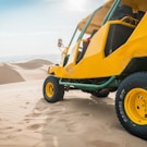 yellow and green UTV parked on a desert field