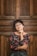 woman leaning against door while holding her cheek