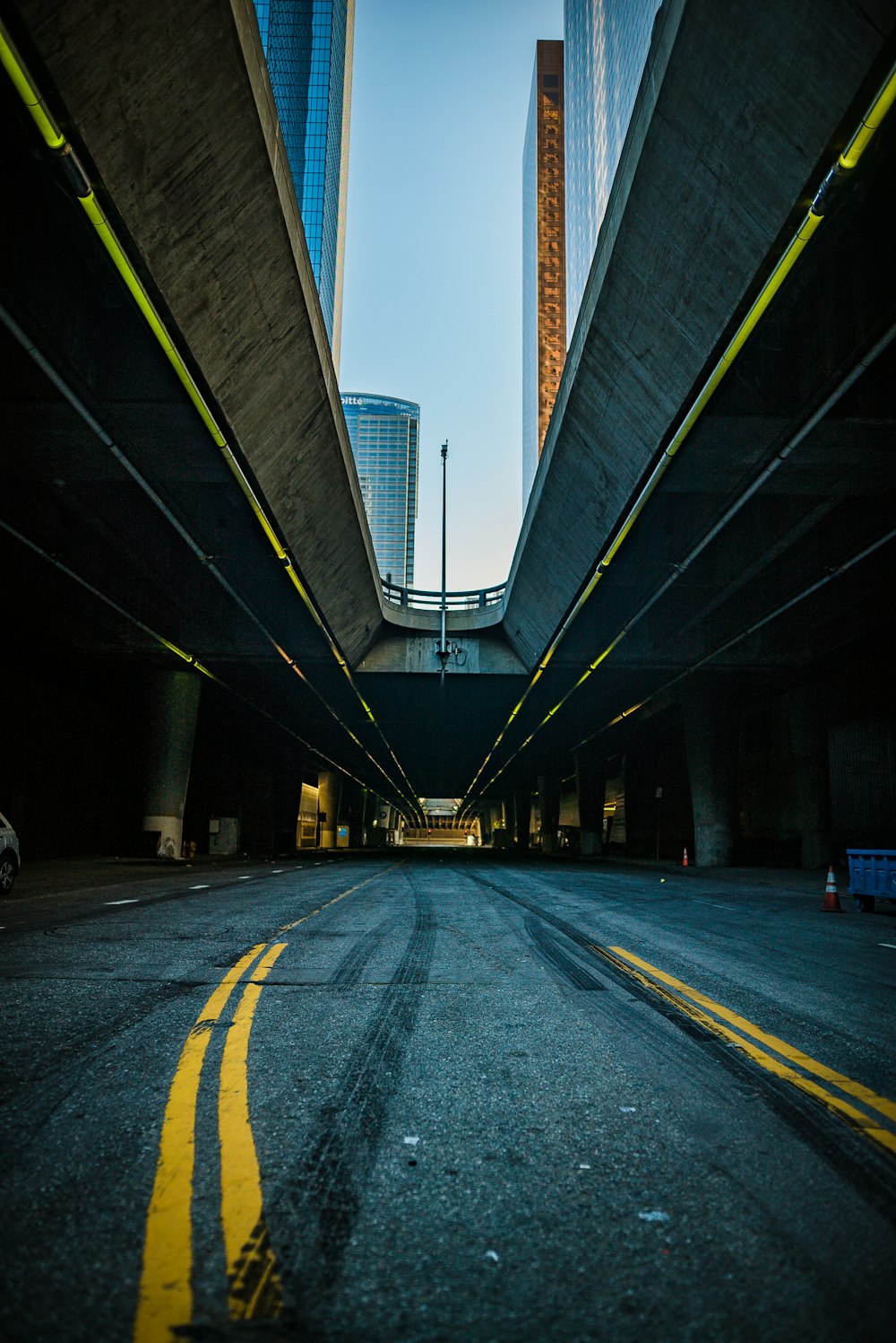 gray concrete bridge near city buildings