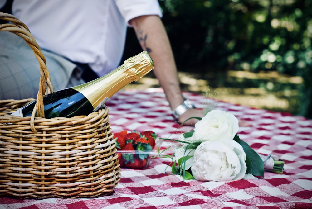 white petaled flower beside basket