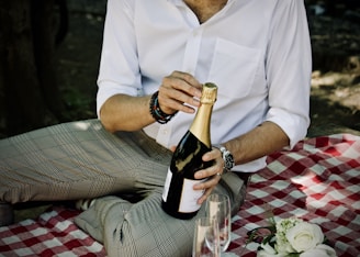 person holding a sealed liquor bottle