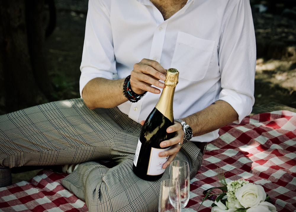 person holding a sealed liquor bottle