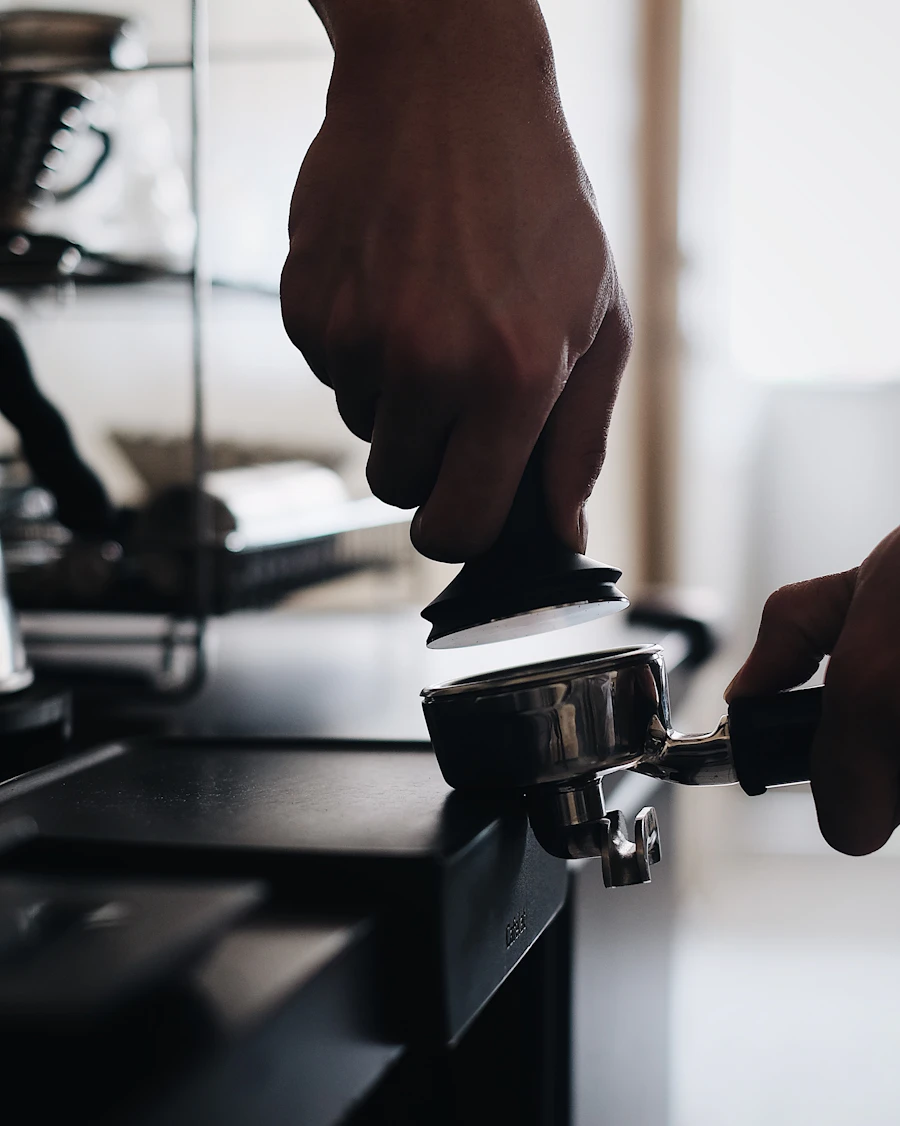 Espresso tamper pressing coffee grounds