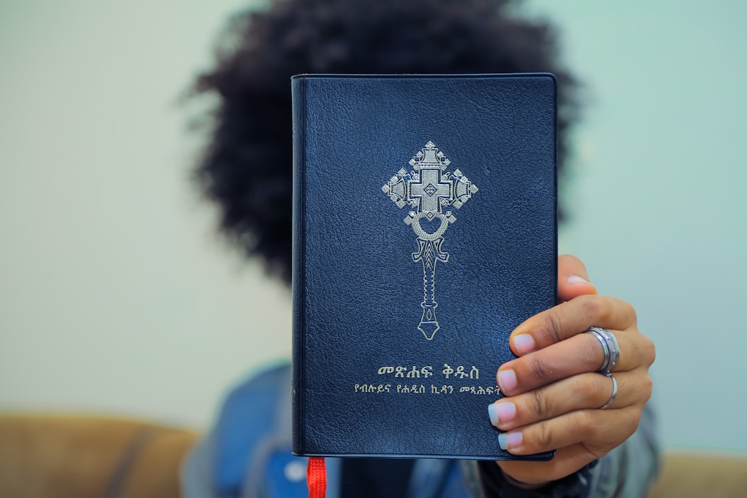 person holding blue book