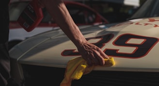 closeup photo of person wiping white racing card