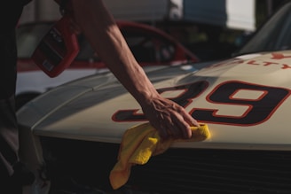 closeup photo of person wiping white racing card