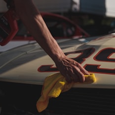 closeup photo of person wiping white racing card