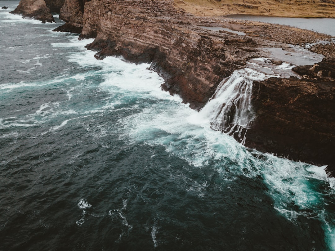 waterfalls near body of water