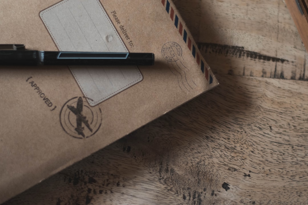 closeup photo of black ballpoint pen on book, Please Deliver To..