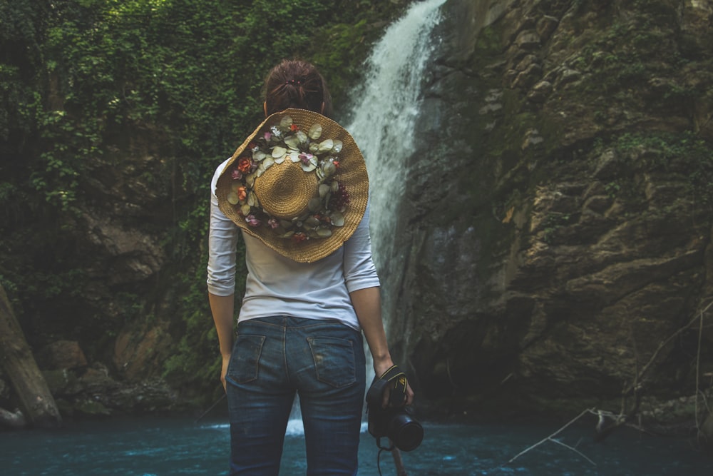 woman standing in front of waterfalls