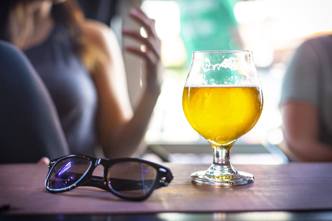 wine glass filled with yellow liquid,