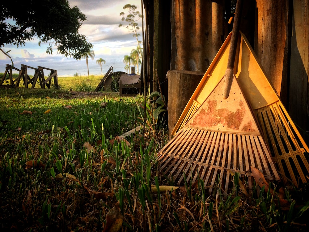 two brown rakes on grasses