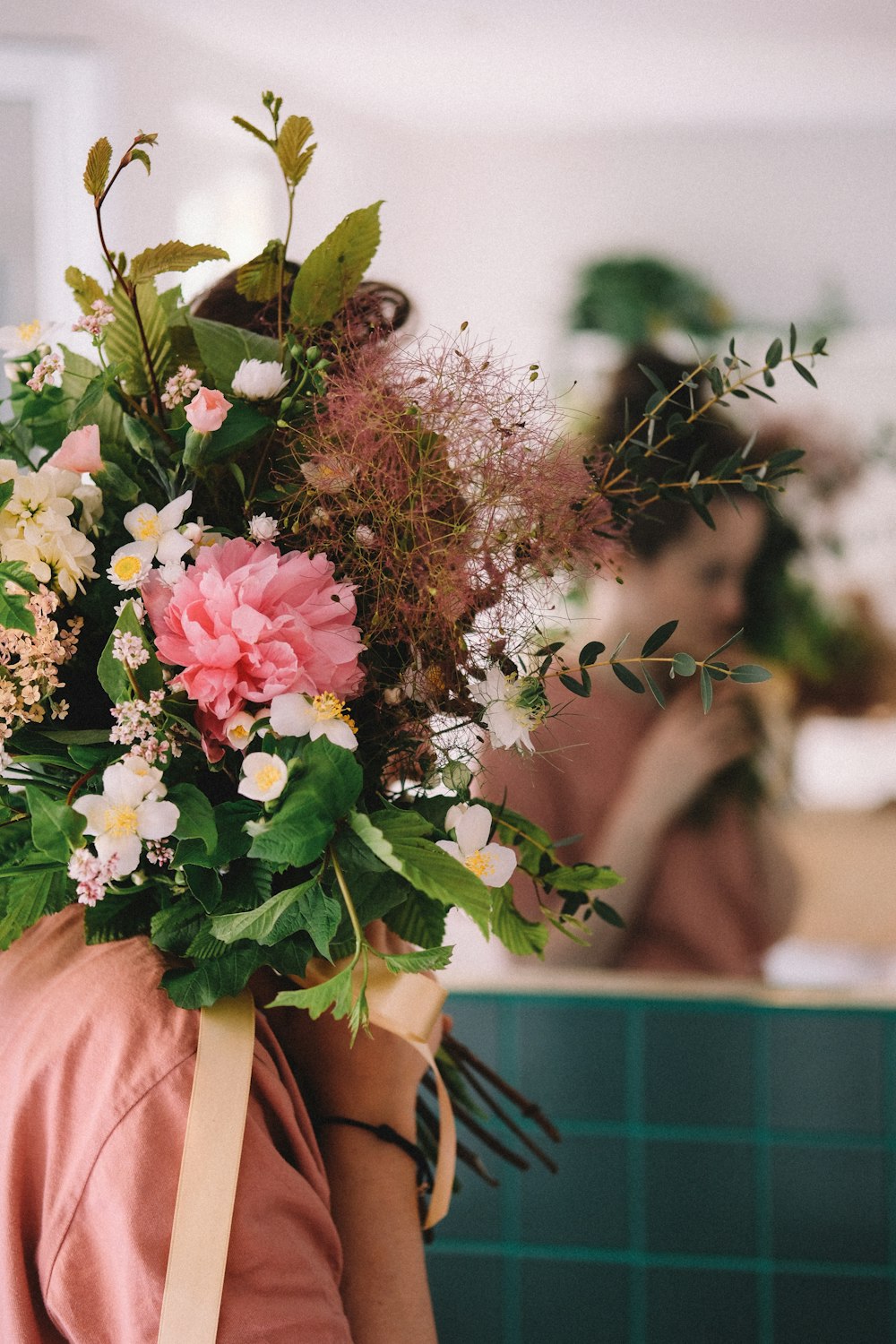 woman holding pink and white flowers