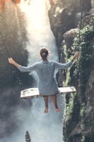 woman riding on wooden swing