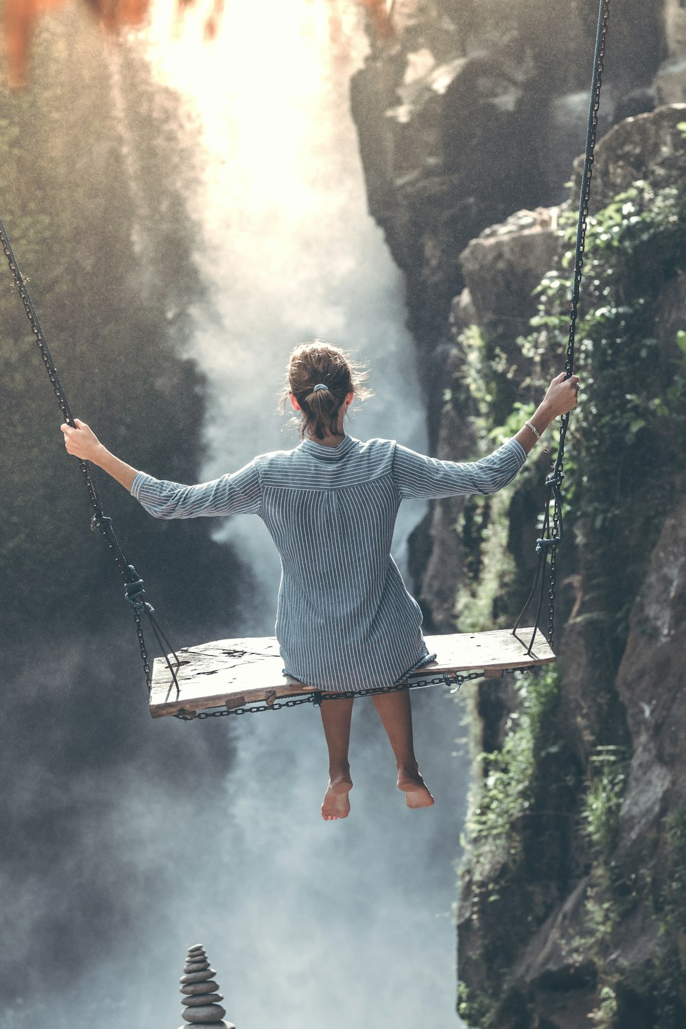 woman riding on wooden swing