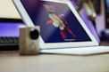 Close-up of hands using Google Workspace apps on a tablet.