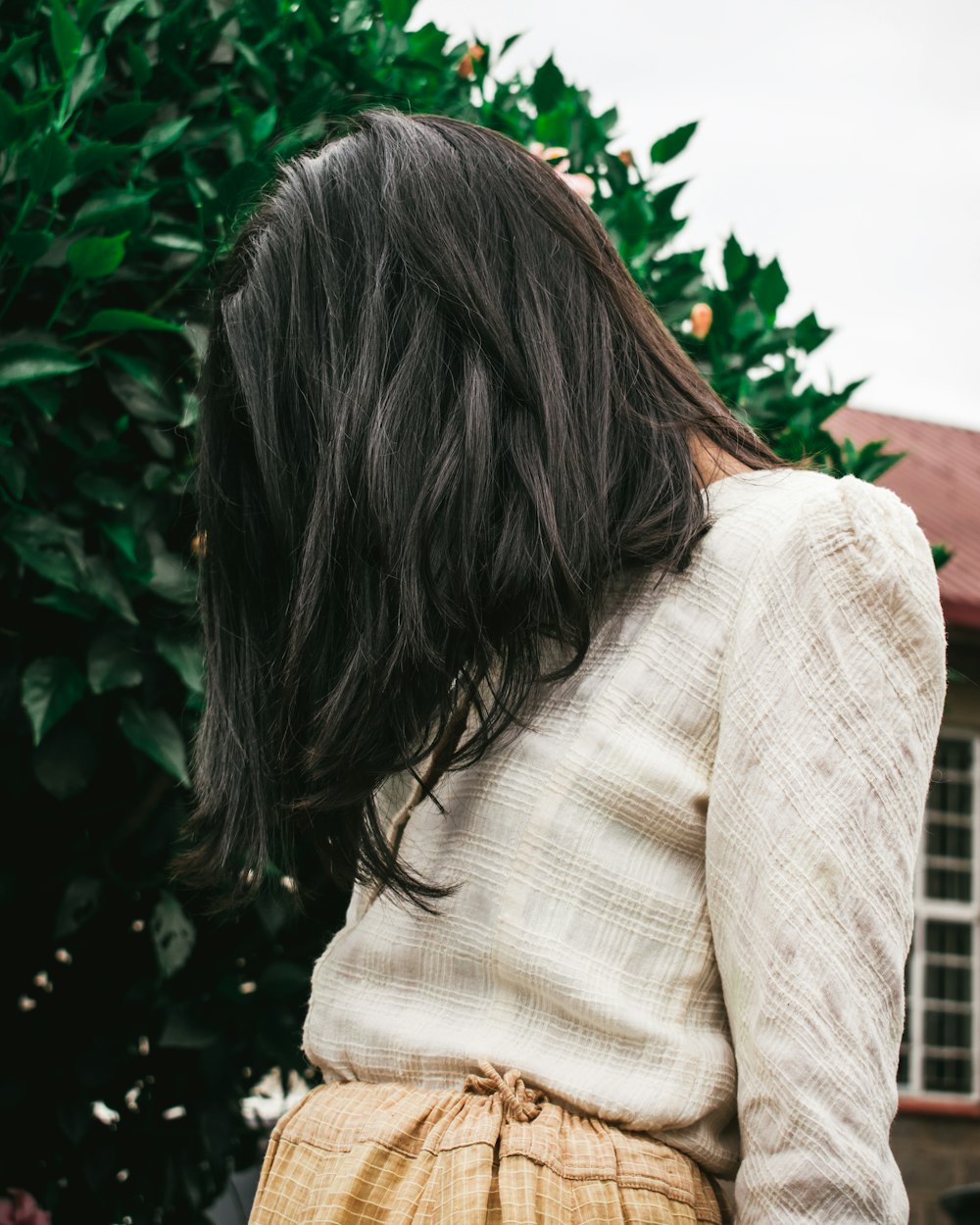 woman in beige long-sleeved top