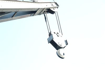 A close-up of a tow truck's winch and hook.