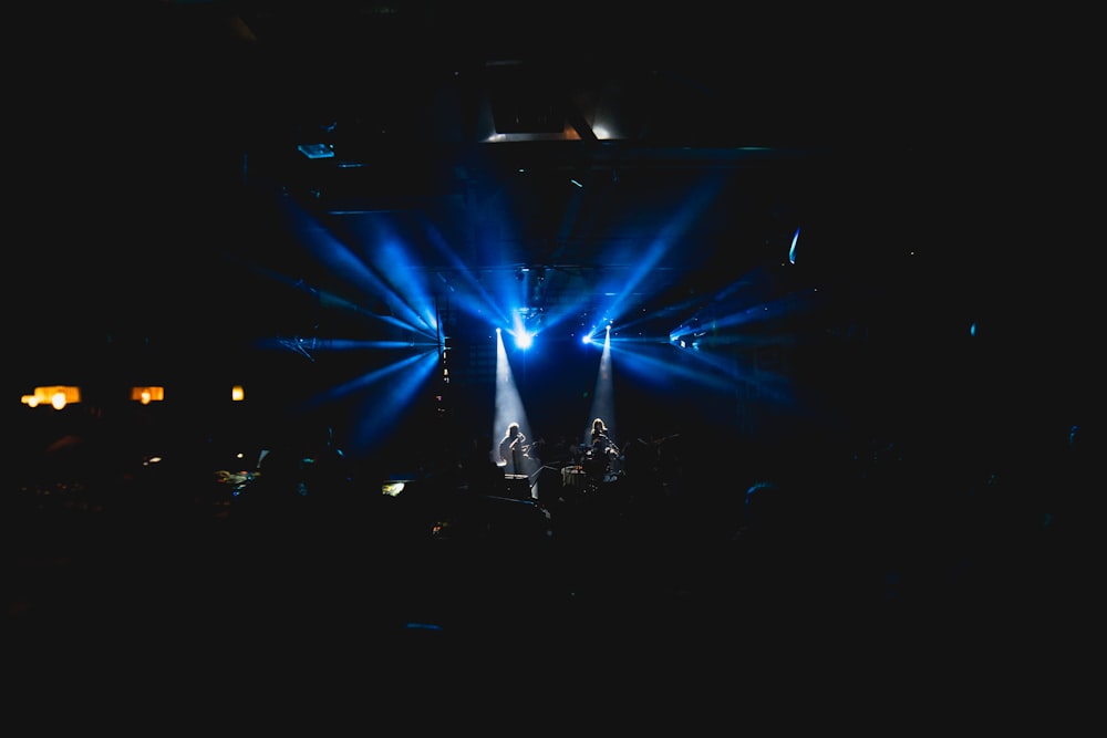 men performing live band on stage in front of crowd