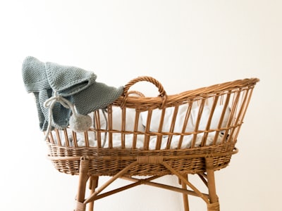 gray textile hanging on brown wicker basket baby google meet background