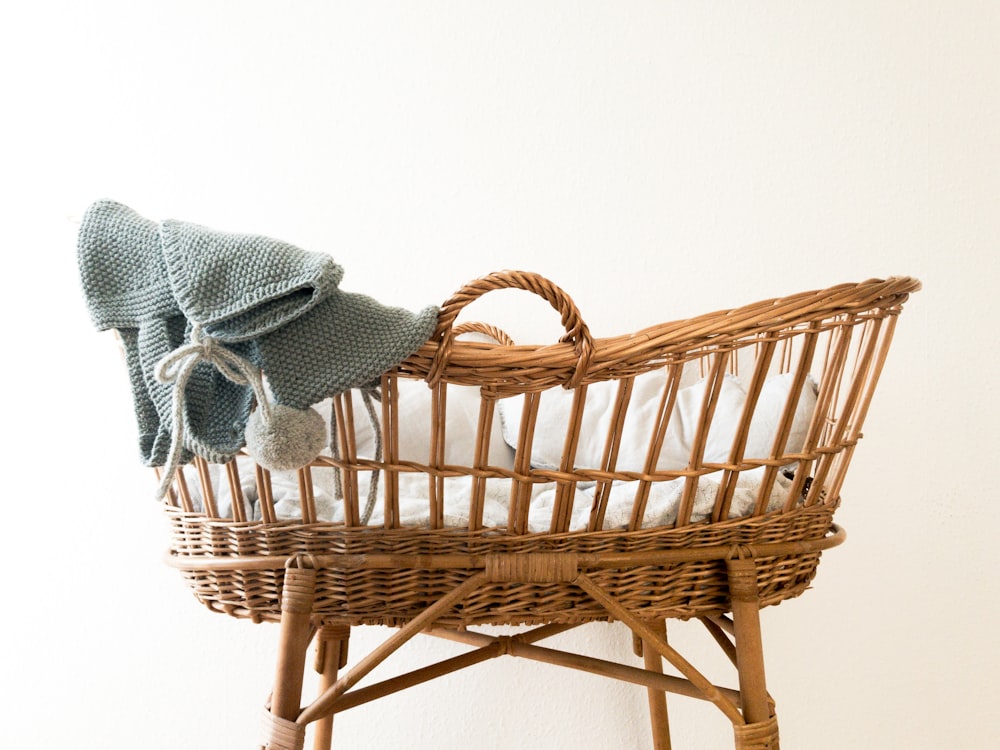 gray textile hanging on brown wicker basket