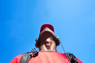 man looking up while wearing black headphones